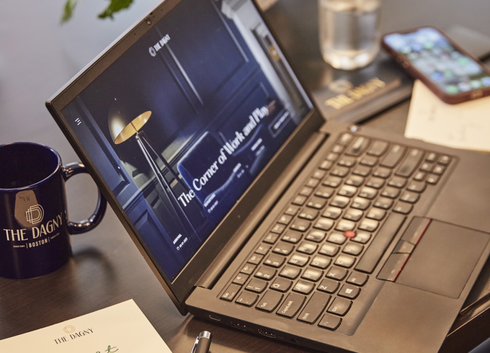 A laptop on a desk with The Dagny homepage open