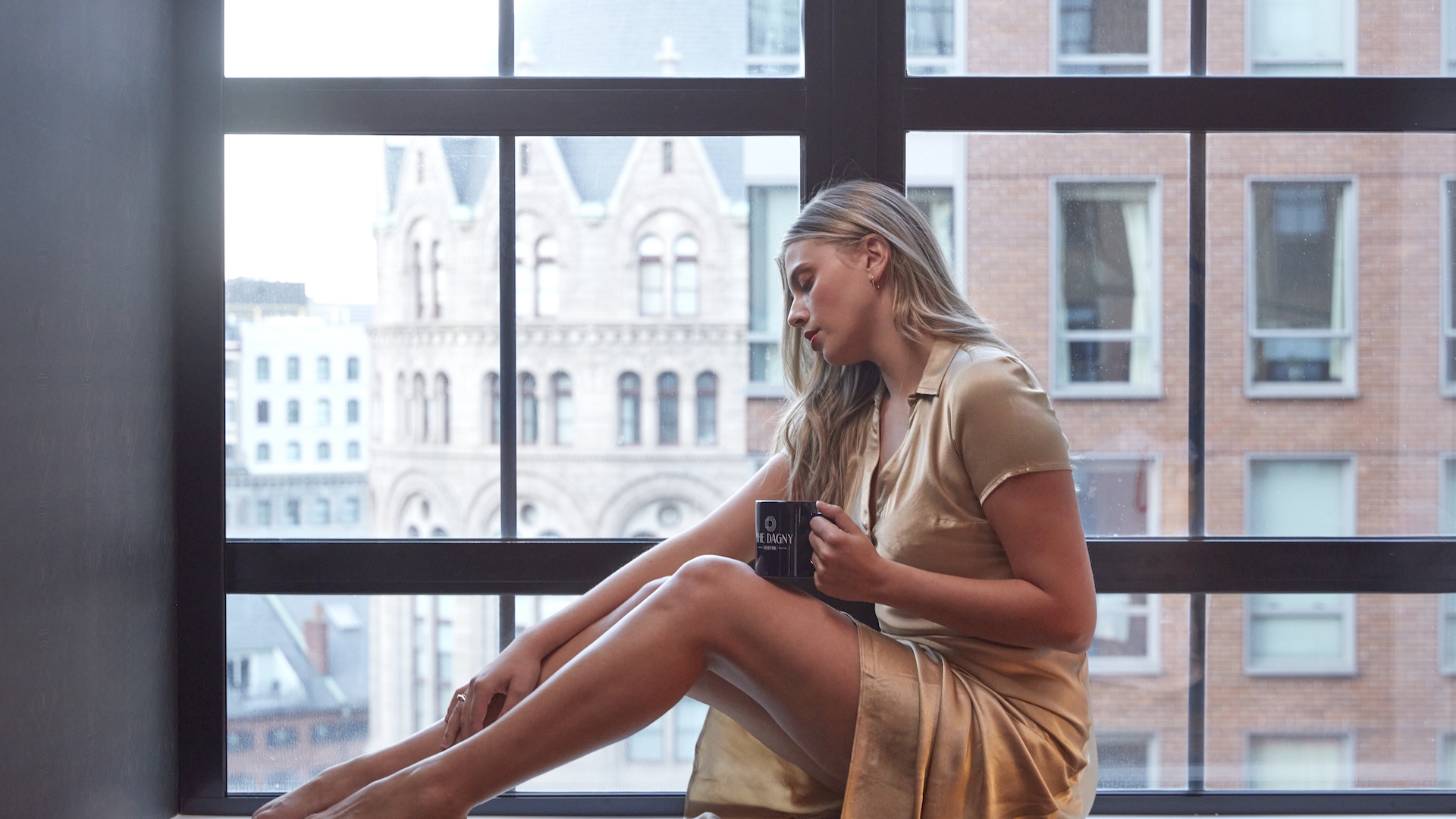 woman sitting in window with Coffee